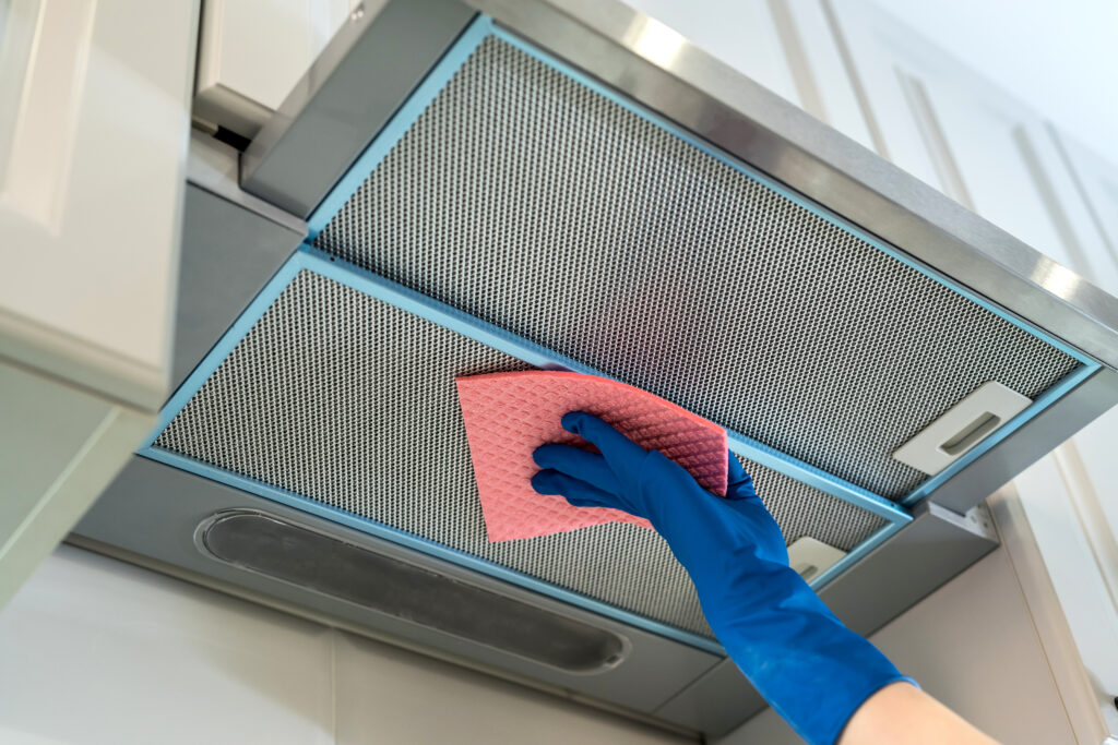 female hand rubber protective a a leaning cooker hood with rag kitchen
