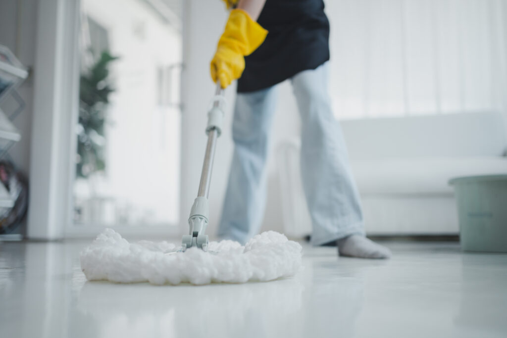Deep Cleaning vs Regular Cleaning: Explaining Key Differences 2 cleaning staff mopping floors home wear apron rubber gloves protect against cleaning chemicals use mop clean floor keep clean inside house prevent germs cleaning ideas
